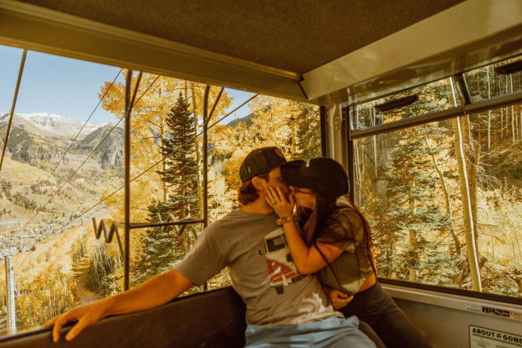 couple poses in Telluride colorado on top of mountain
