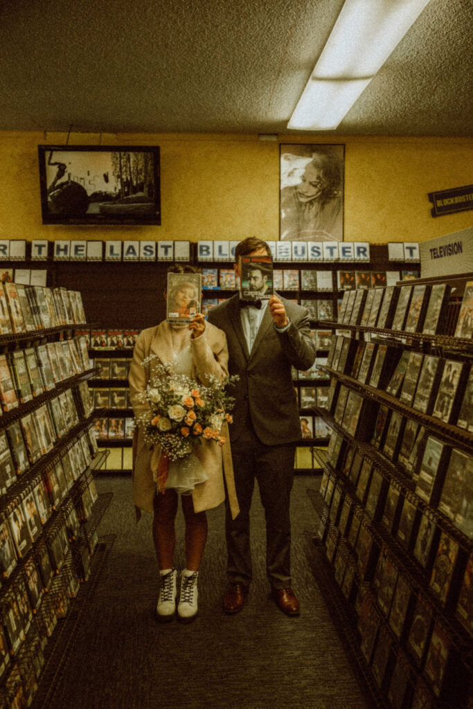 how to elope with photo of bridal couple at the last blockbuster on earth in bend oregon