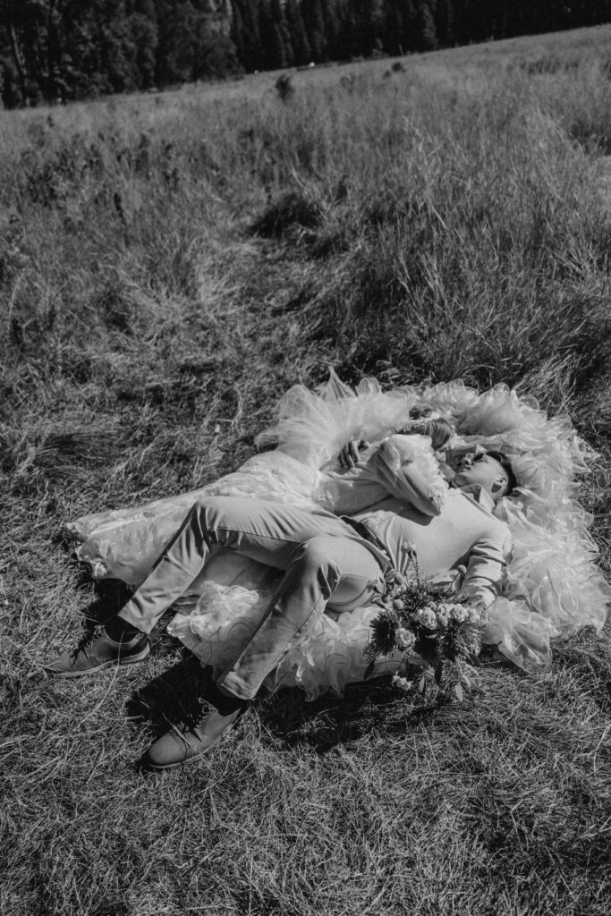 couple laying down in half dome meadow for their destination elopement in yosemite shot on film 