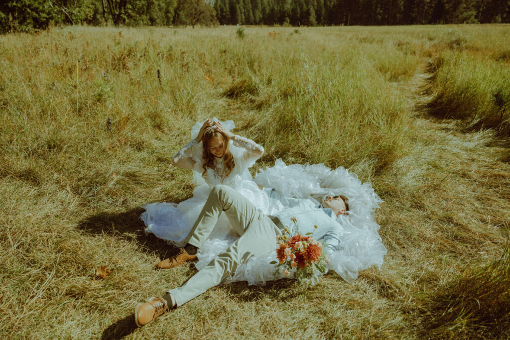 couple laying down in half dome meadow for their destination elopement in yosemite shot on film 