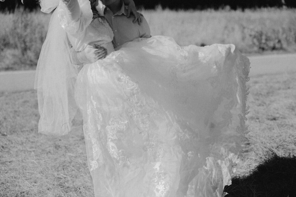 black and white film photo of bride and groom holding eachother in yosemite national park 