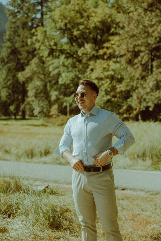 groom posing in vintage thrifted dress for destination elopement in yosemite national park california