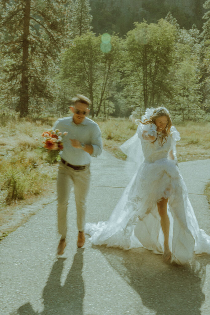 couple running in half dome meadown at yosemite national park for their deestination elopement 