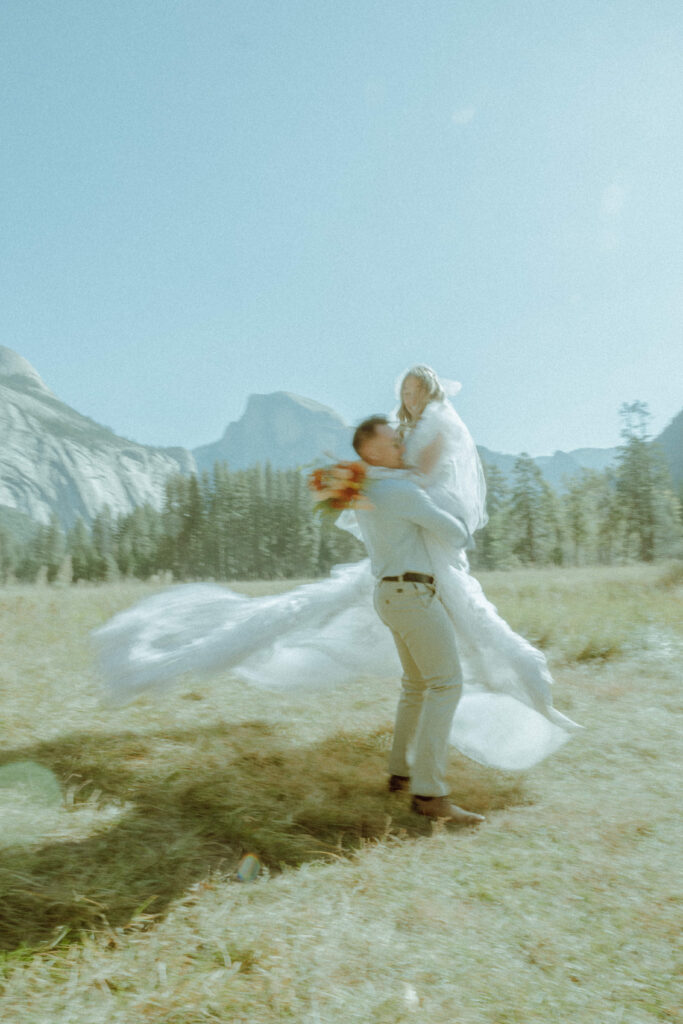 couple kissing in half dome meadown at yosemite national park for their deestination elopement 