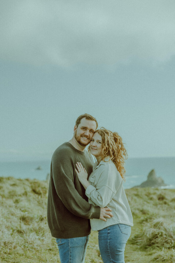 couple posing for their destination engagement photos at Samuel H Boardman state park on the oregon coast