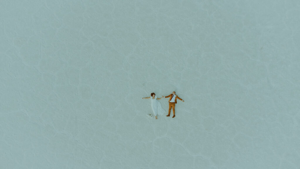 drone photo of groom and bride at destination elopement at the salt flats in utah 
