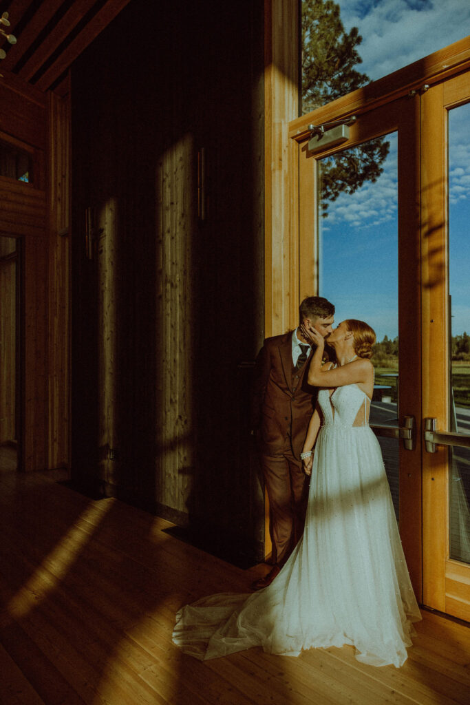 bride and groom pose for a kiss at black butte ranch wedding 