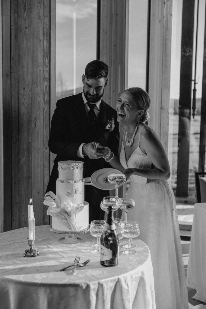 bride and groom at black butte ranch wedding venue in bend oregon cutting cake