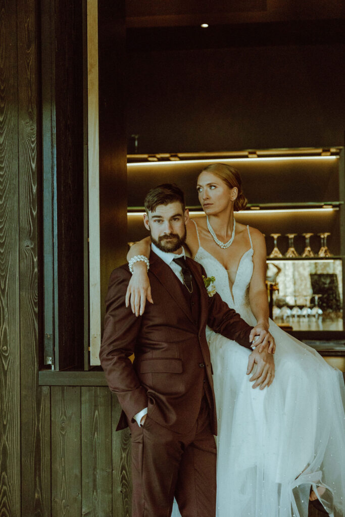 bride and groom pose at bar top in black butte ranch wedding 
