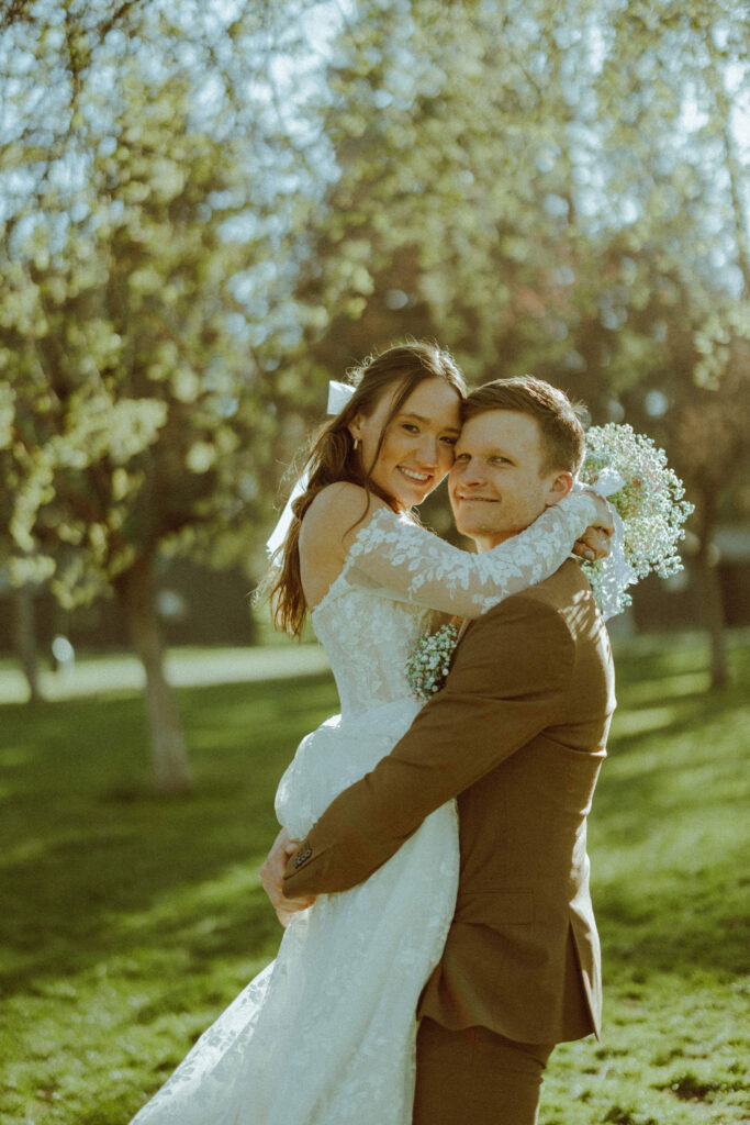 bride and groom posing at hollinshead barn wedding venue in hollinshead park bend oregon 