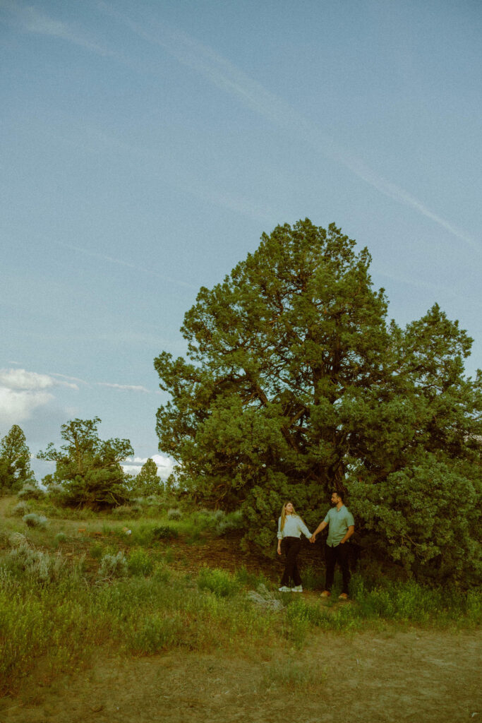 girl and boy walking for engagement photos in oregon badlands