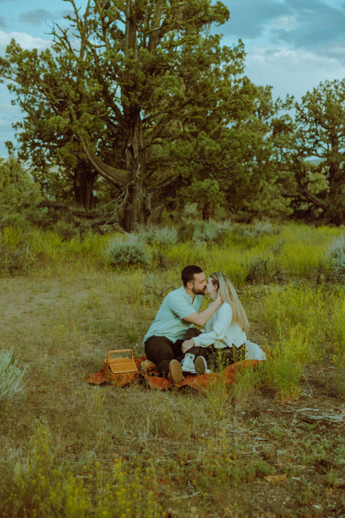 engaged couple kissing for photo during oregon badlands engagement session in bend oregon 