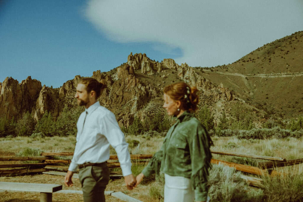 bride and groom walking at smith rock elopement in oregon