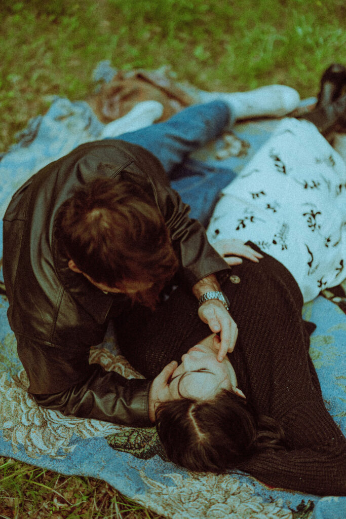 couple on a blanket at their oregon engagement session in the gorge