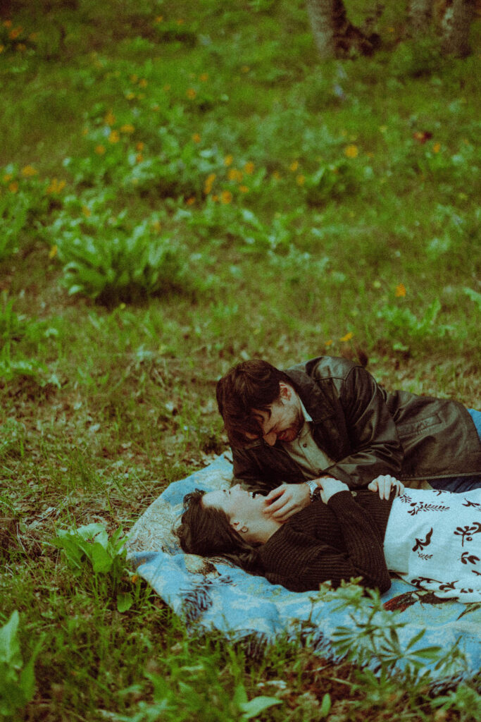 couple on a blanket at their oregon engagement session in the gorge