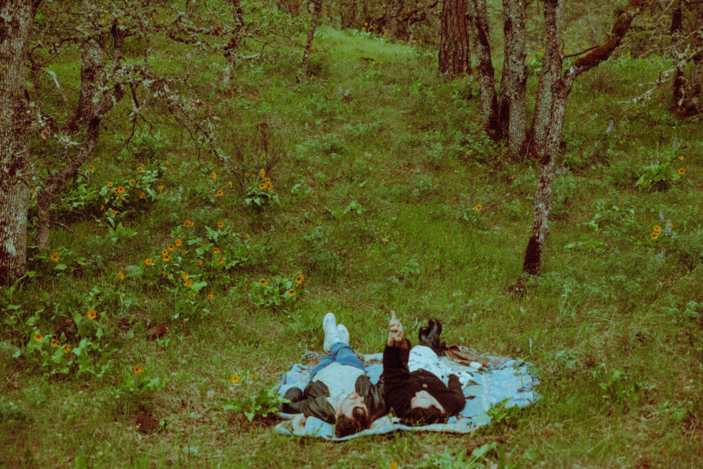 couple on a blanket at their oregon engagement session in the gorge