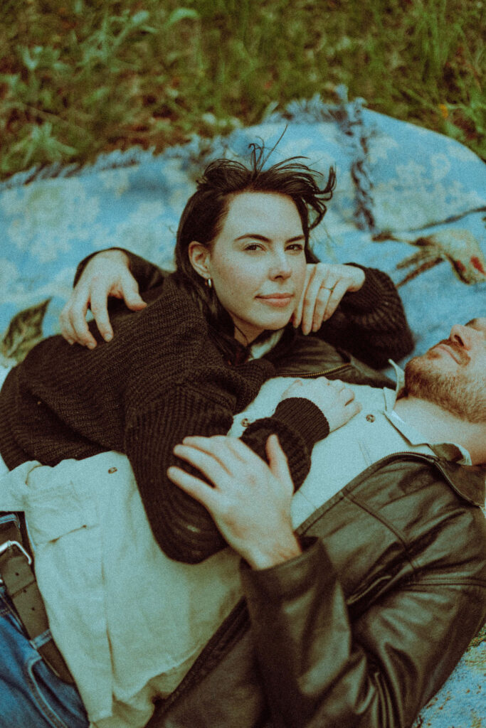 couple on a blanket at their oregon engagement session in the gorge