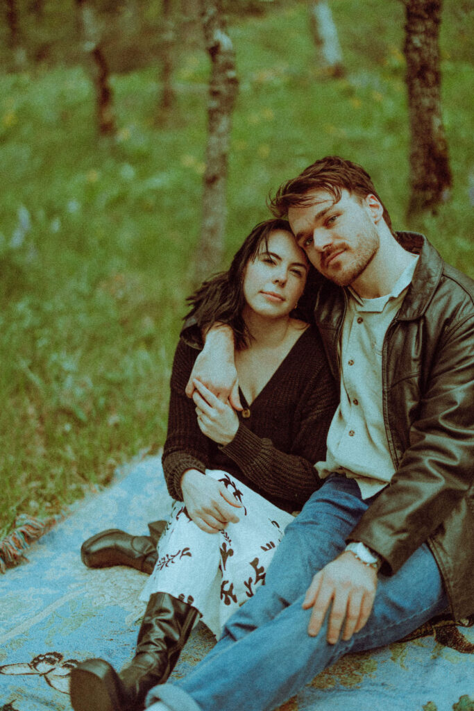 couple on a blanket at their oregon engagement session in the gorge