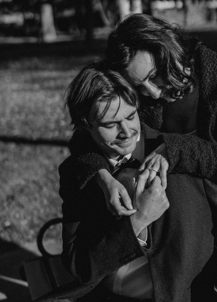 couple posing on a park bench in bend oregon for their editorial engagement photos