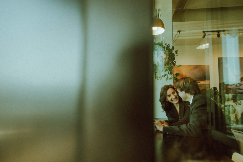 bride and groom facing eachother in a cafe looking through a window in bend oregon