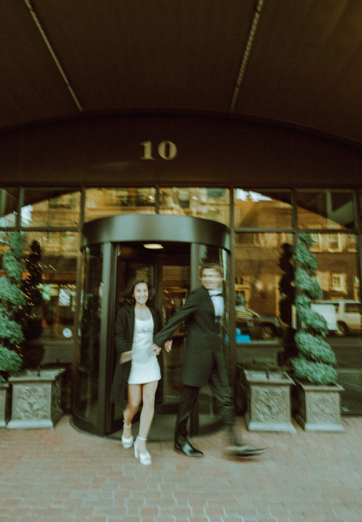 bride and groom run out of rotating automatic door at oxford hotel in bend oregon