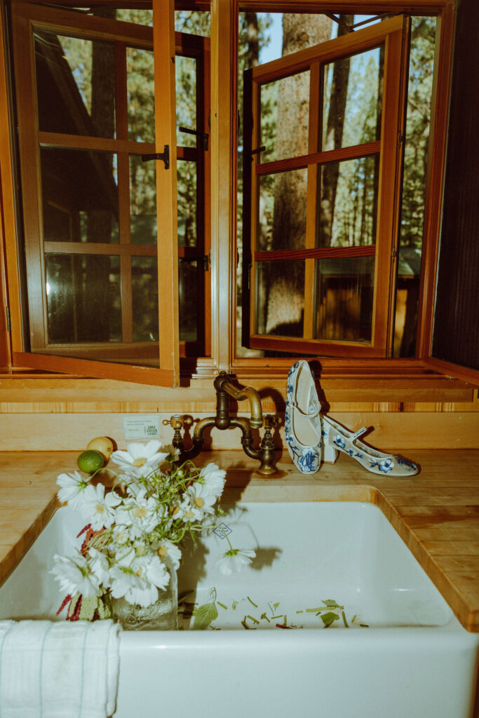 brides shoes and bouquet at sink in cabin at lake creek lodge in central oregon 