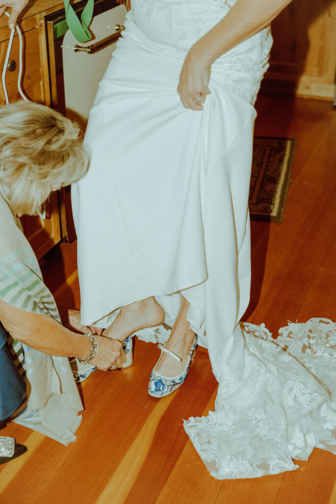 mob putting on brides wedding shoes 