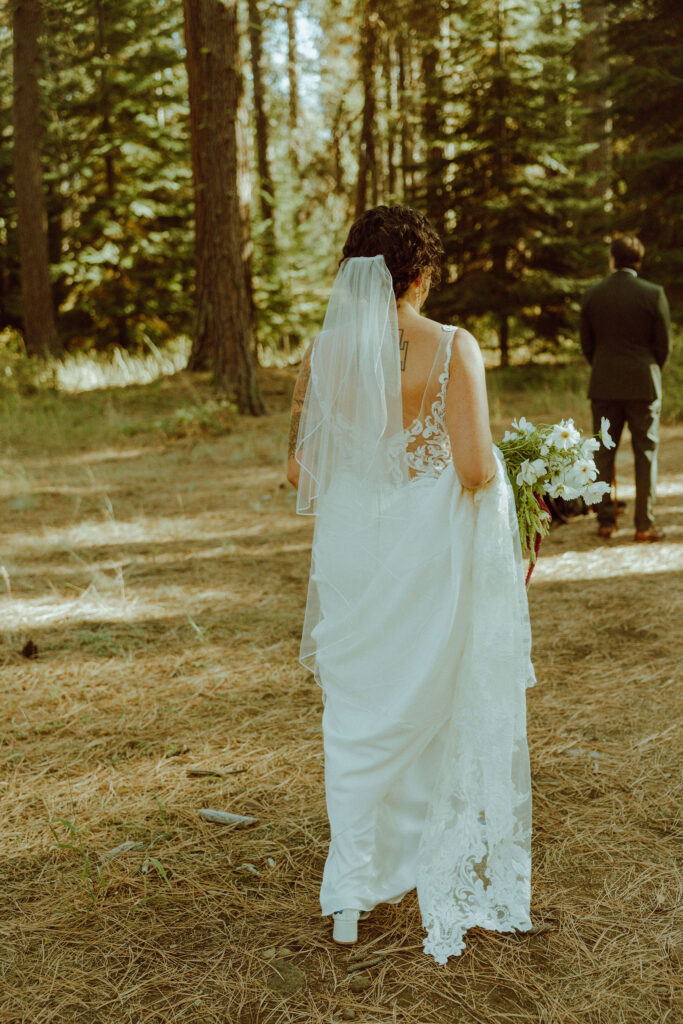 bride and groom first look in the forest at their wedding at lake creek lodge in oregon