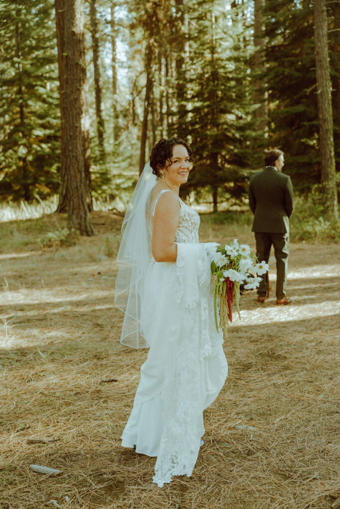 bride and groom first look in the forest at their wedding at lake creek lodge in oregon