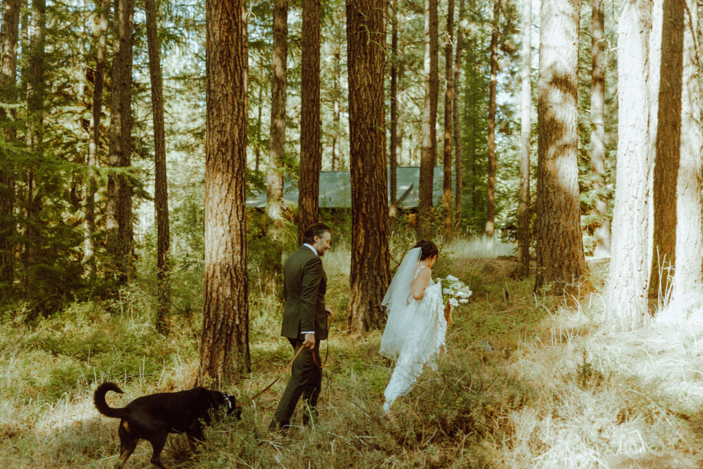 bride and groom walking in the forest camp sherman oregon