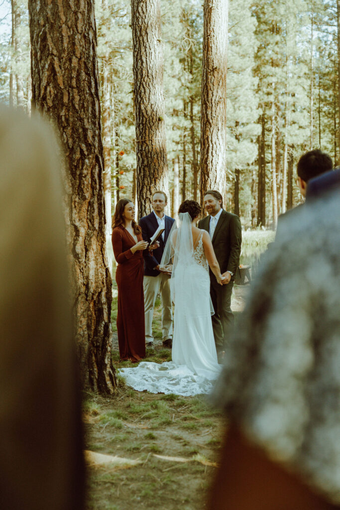 bride at groom standing at their wedding ceremony at lake creek lodge