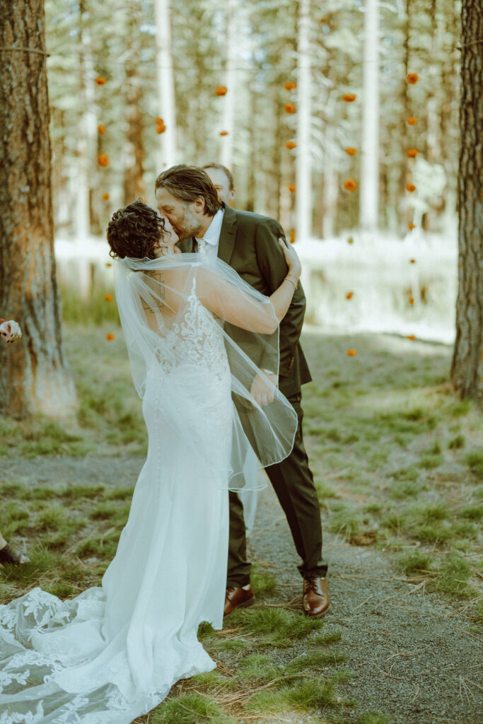 bride and groom first kiss at wedding ceremony