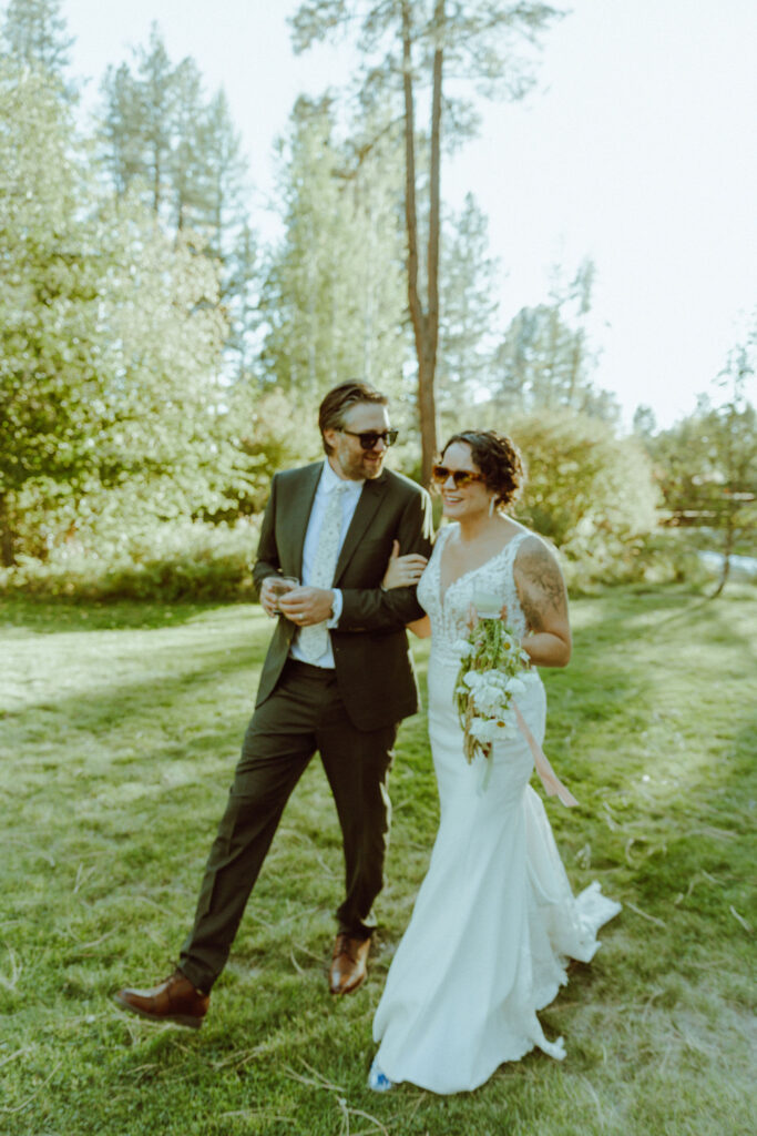 bride and groom walking at lake creek lodge