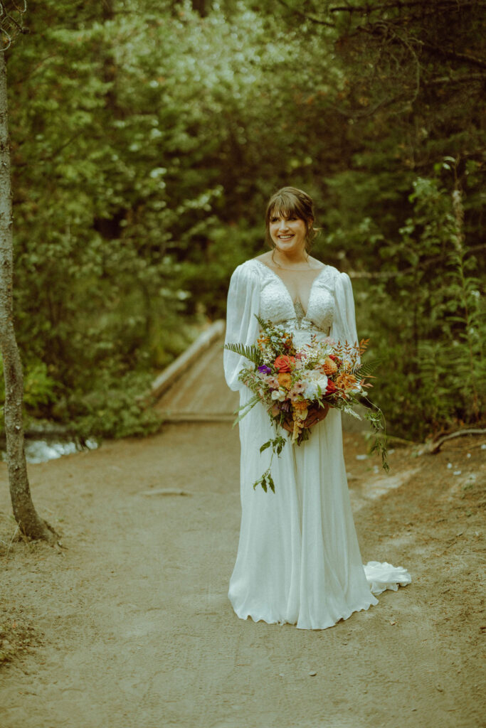 bride posing in wedding dress smiling 