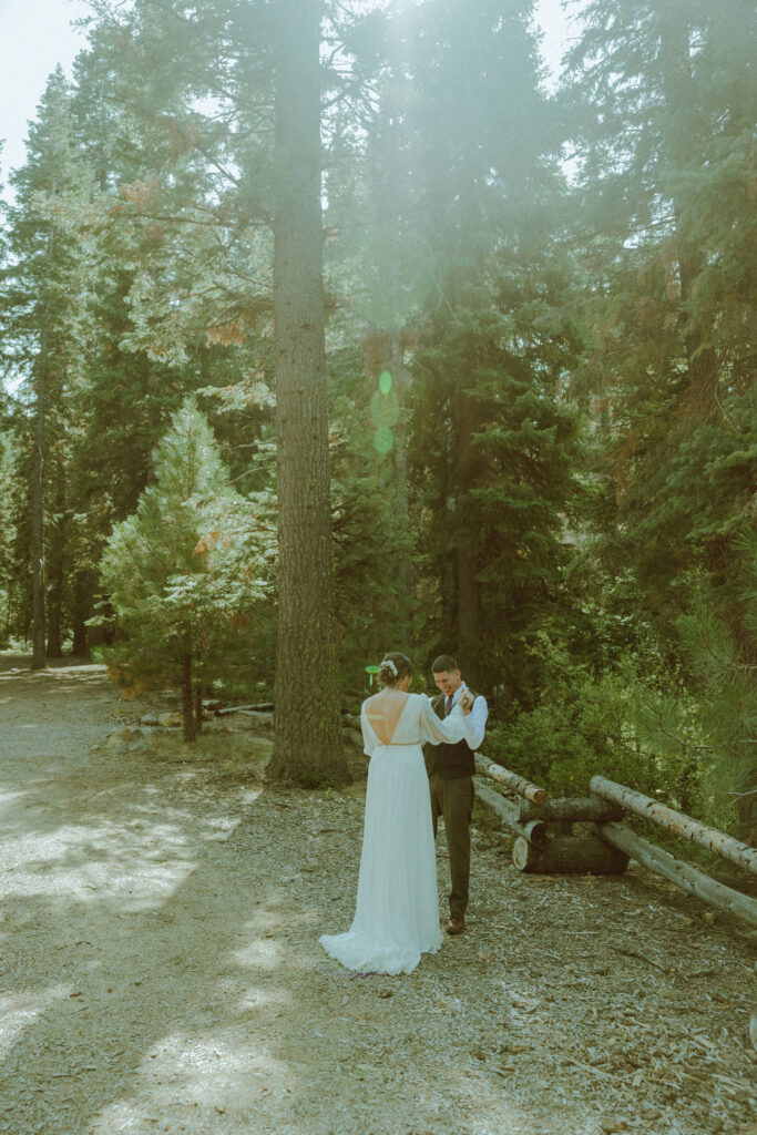 bride and groom first look at skyliner lodge wedding in the forest bend oregon