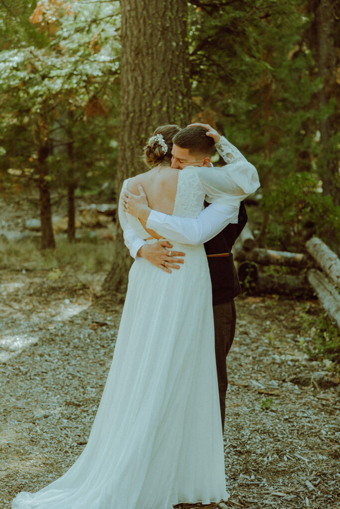 bride and groom first look at skyliner lodge wedding in the forest bend oregon