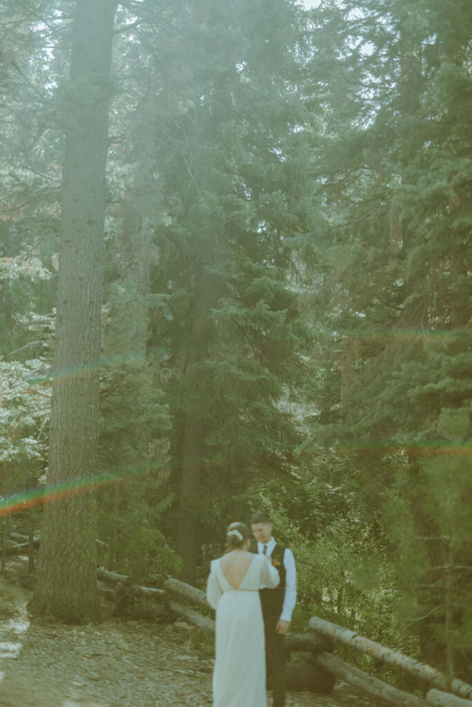 bride and groom first look at skyliner lodge wedding in the forest bend oregon