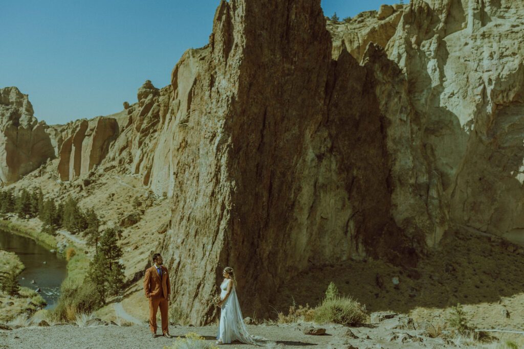 bride and groom pose for photo at smith rock state park 