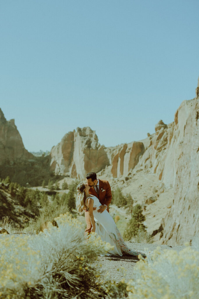 bride and groom kiss on their wedding day at smith rock state park 