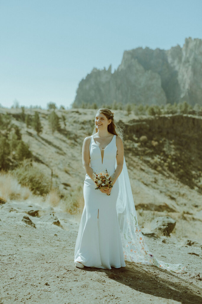 bride smiles for photo at smith rock 