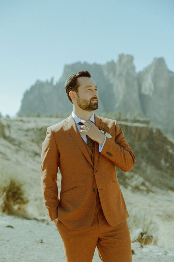 groom adjusting his tie 