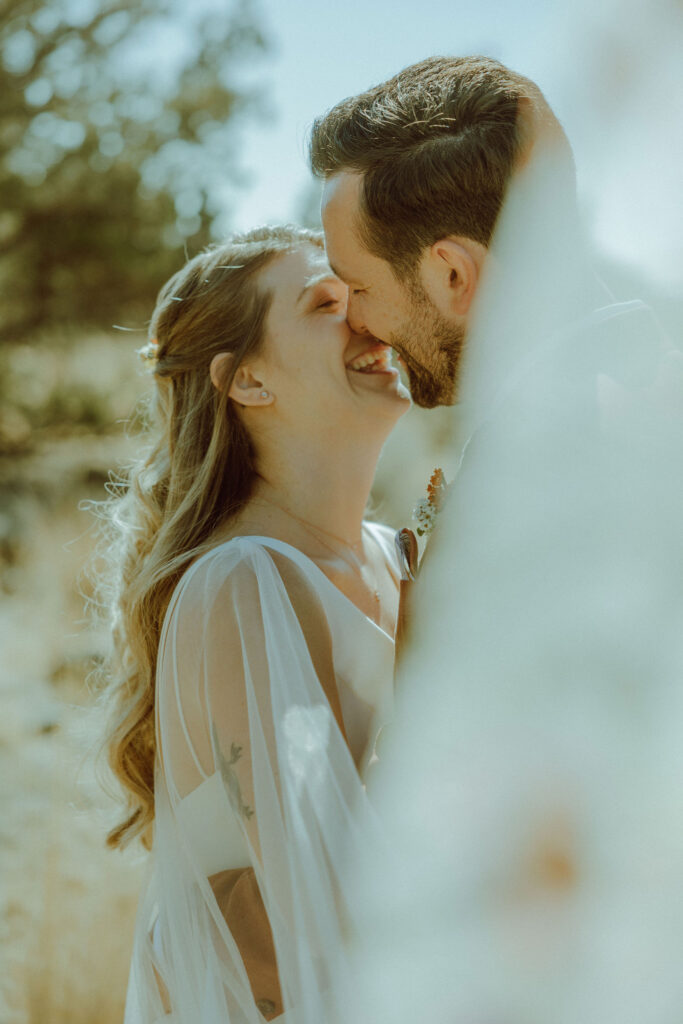 bride and groom smiling at eclectic wedding at smith rock state park 