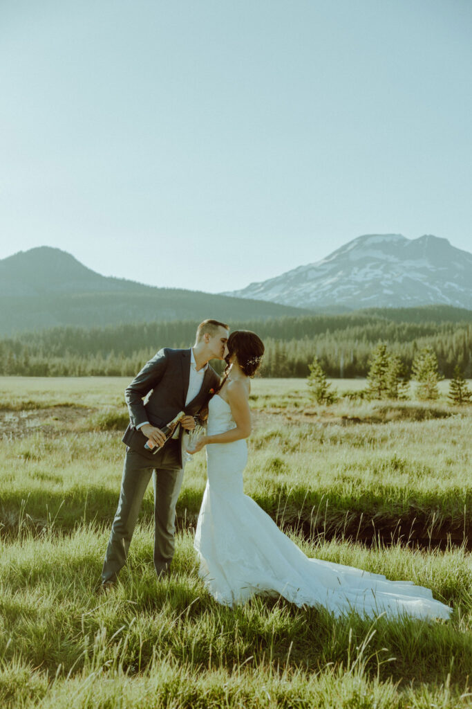 sparks lake oregon elopement bride and groom spray champagne 