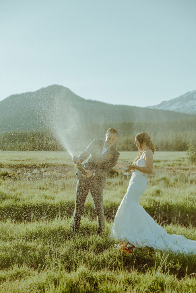 sparks lake oregon elopement bride and groom spray champagne 