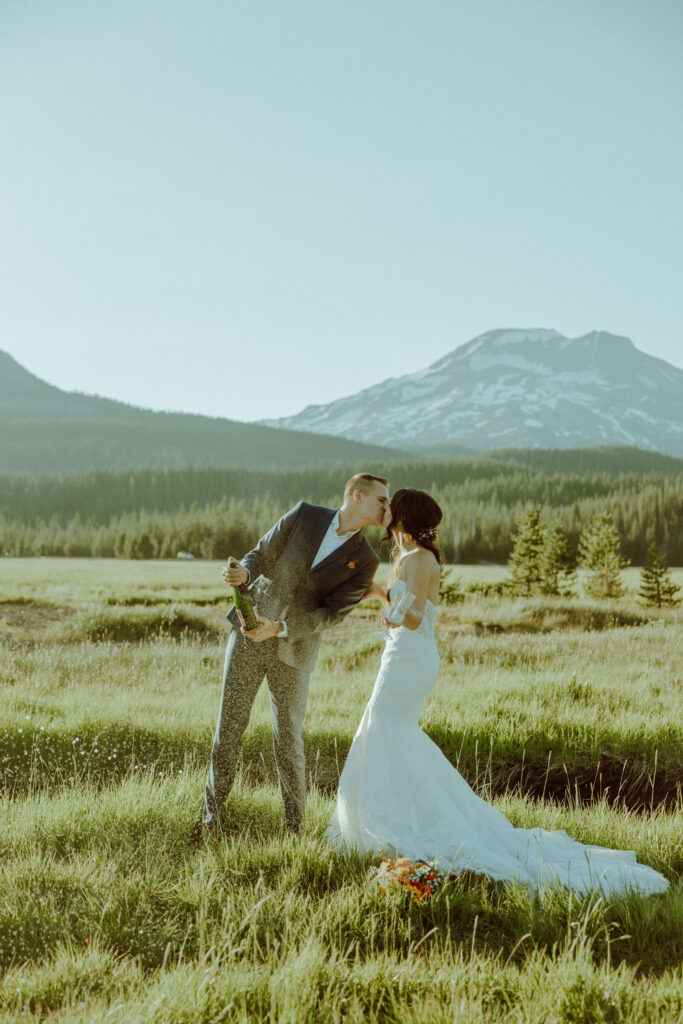 sparks lake oregon elopement bride and groom spray champagne 