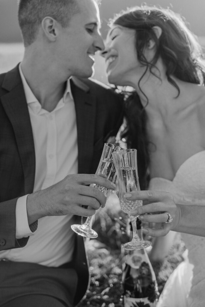 bride and groom drinking champagne at bend oregon adventure elopement at sparks lake meadow