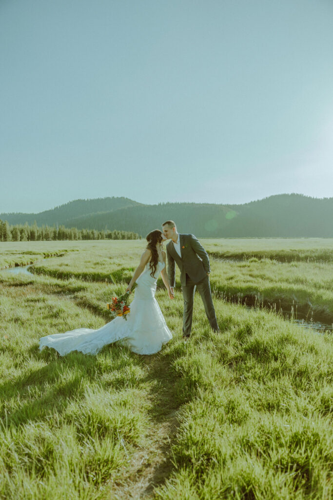 bride and groom pose for photo at sparks lake oregon elopement location in bend 