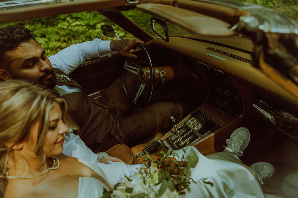 oregon bride and groom posing with a vintage car for their adventure elopement 