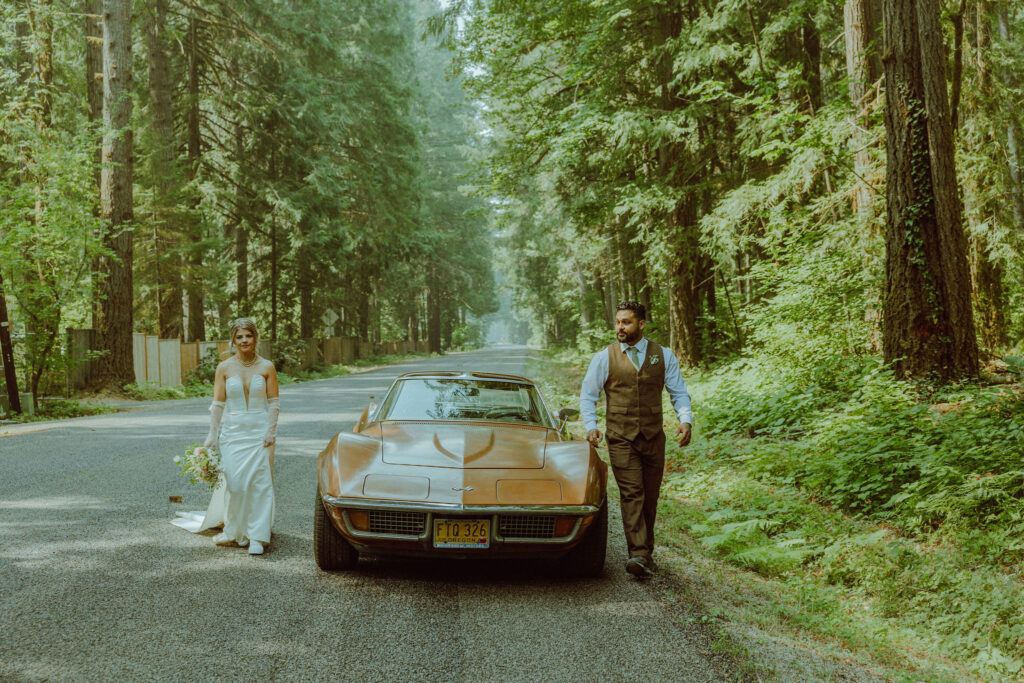 oregon bride and groom posing with a vintage car for their adventure elopement 