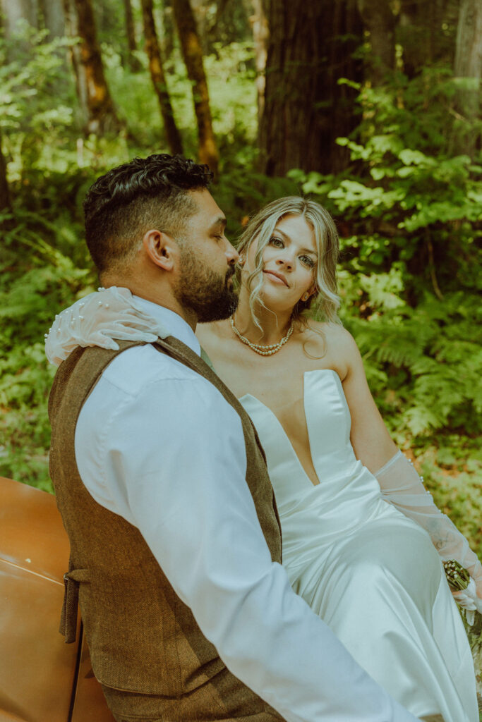 oregon bride and groom posing with a vintage car for their adventure elopement 